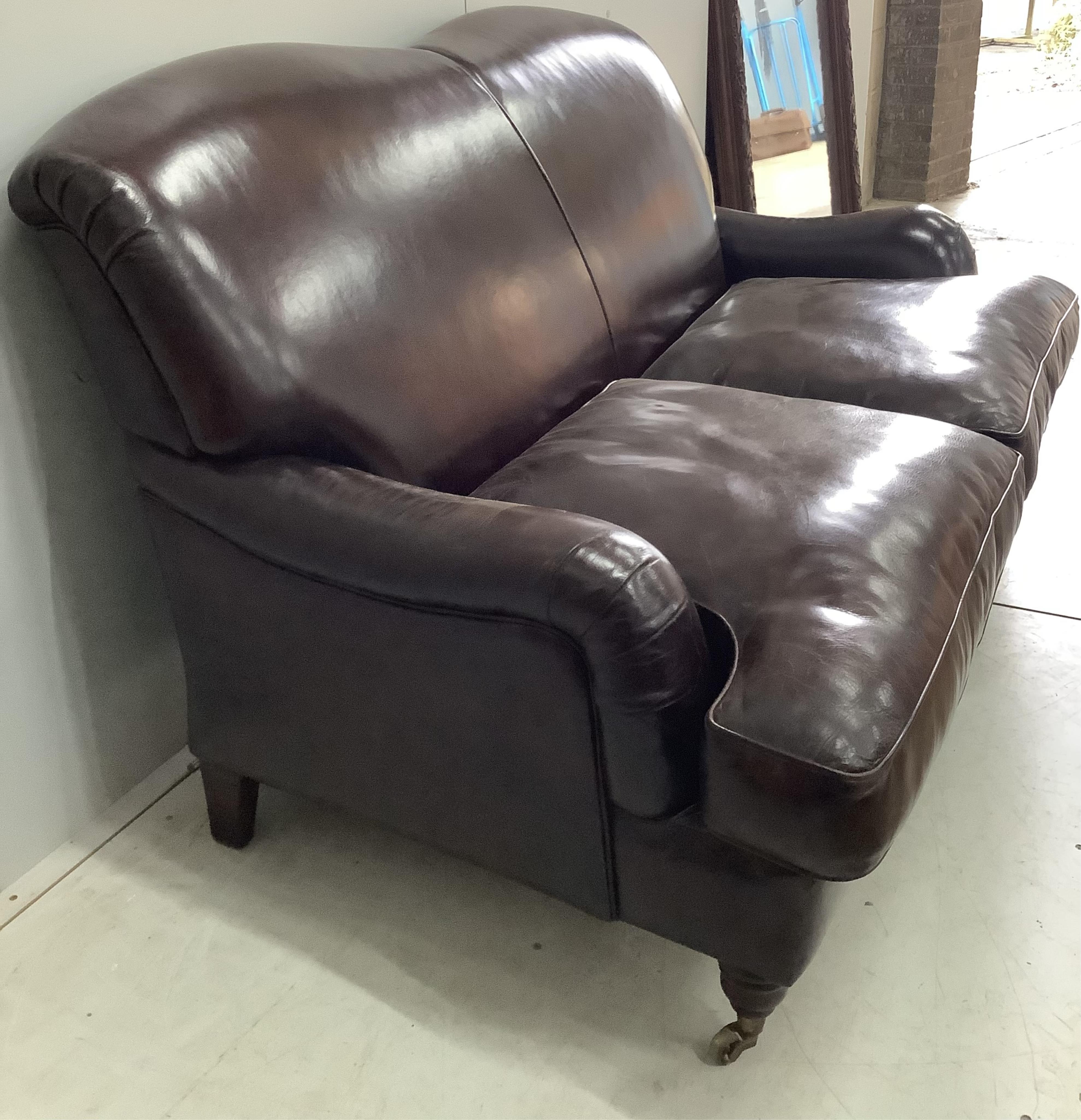 A modern Howard style brown leather two seater settee, width 158cm, depth 88cm, height 88cm. Condition - fair to good